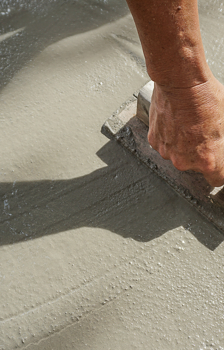 Man smoothing wet concrete
